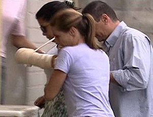 FRAME jovem baleada no carro de Adriano chega a delegacia (Foto: Reprodução / TV Globo)
