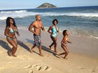 MV Bill corre com as irmãs na praia