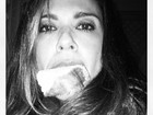Luciana Gimenez assalta a geladeira e come pedação de bolo