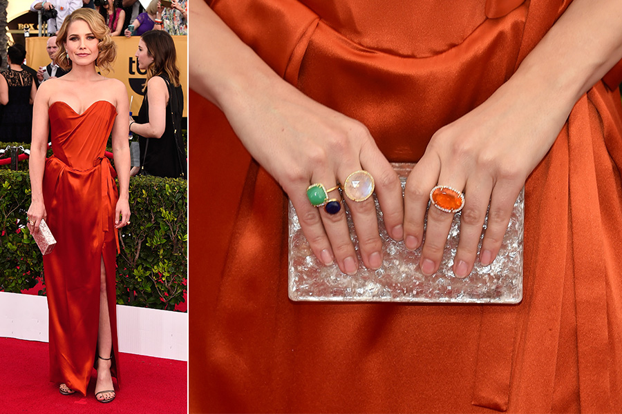 Para combinar com o vestido laranja, Sophia Bush apostou em mix de aneis com pedras coloridas e uma clutch prateada