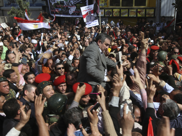 O premiê Essam Sharaf nos braços do povo nesta sexta-feira (4)  na Praça Tahrir, no centro do Cairo. (Foto: AP)