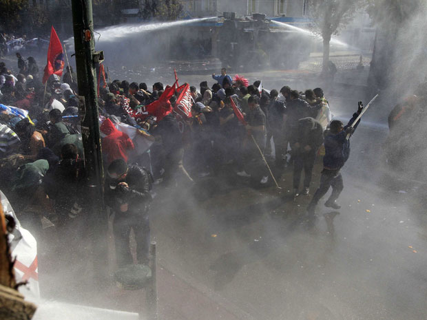Manifestantes são dispersados pela polícia com jatos de água em um protesto contra o governo em Valparaiso, no Chile. (Foto: Ivan Alvarado/Reuters)