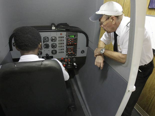 Instrutor de voo explica procedimentos de simulador a estudante em escola de aviação da flórida (Foto: AP)