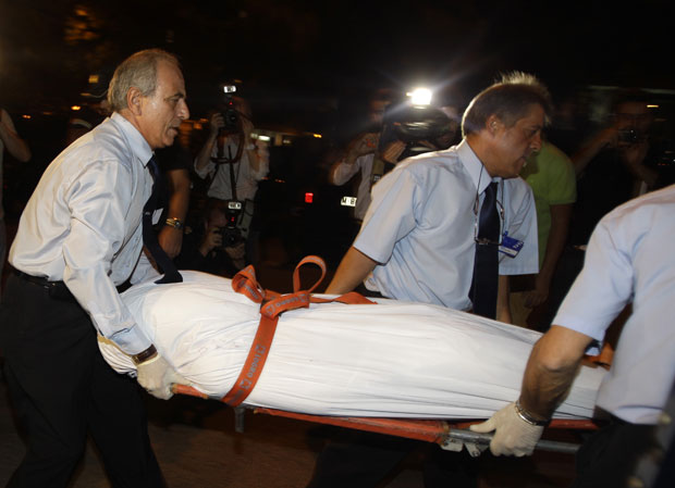 Corpo é retirado de dentro da igreja em Madri nesta quinta-feira (29) (Foto: AP)