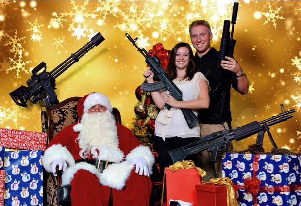clube de tiro de Scottsdale, no estado do Arizina (EUA), oferece a oportunidade de sócios e não sócios de posar com suas armas com o Papai Noel. (Foto: Reprodução)