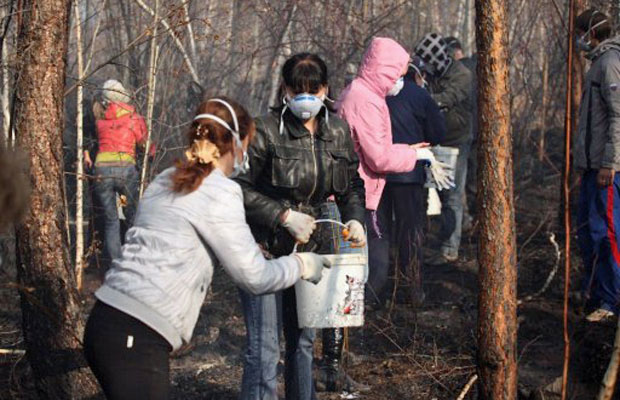 Voluntários ajudam a apagar fogo em área de floresta na cidade russa de Bratsk (Foto: AFP)