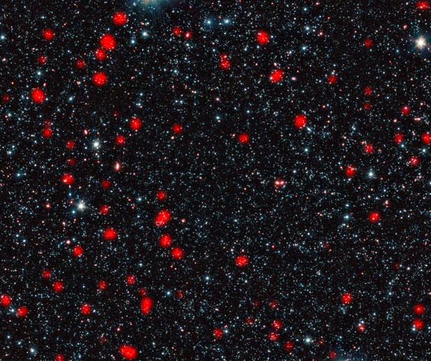 Formação estelar explosiva, tipo de formação estelar mais intensa que se conhece, registrada na constelação de Fornax (Foto: ESO, APEX (MPIfR/ESO/OSO), A. Weiss et al., Nasa Spitzer Science Center)