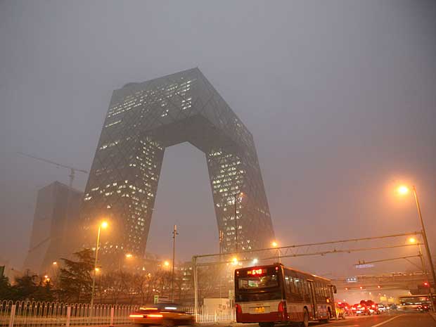 A torre ‘China Central Television’ (CCTV) quase desapareceu sob a névoa criada pela poluição que cobriu a maior parte de Pequim neste sábado (17). O fenômeno atmosférico cancelou ou atrasou mais de 400 voos no aeroporto da cidade, incluindo 35 voos internacionais. (Foto: AFP Photo)
