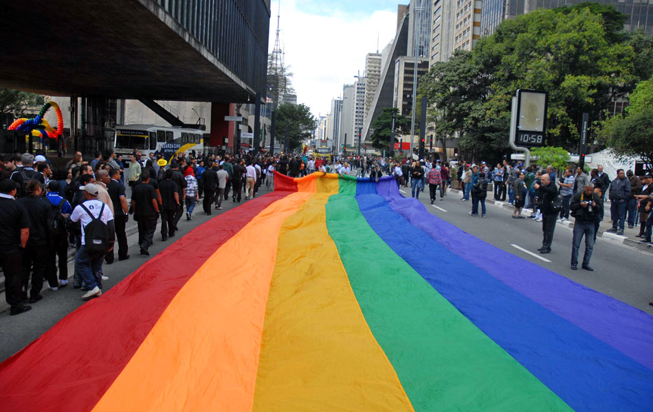 Bandeira colorida é colocada no meio da Avenida Paulista antes do início da Parada Gay