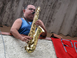 Da varanda de casa, um simpatizante de DIlma toca saxofone.