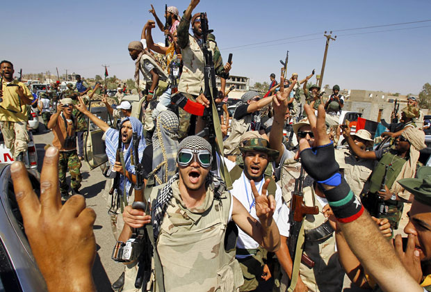 Rebeldes líbios comemoram a tomada de controle de mais uma vila pró-Kadhafi, em Gohta, neste domingo (18) (Foto: Francois Mori/AP)