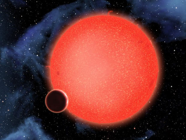 Imagem divulgada pela Nasa mostra o planeta orbitando uma estrela vermelha há 40 anos-luz da Terra.  (Foto: AFP Photo / Nasa / ESA / D.Aguilar)